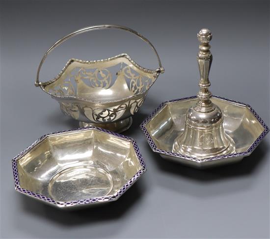 A silver hand bell, a silver bonbon basket and a pair of George V silver and enamel octagonal bowls.